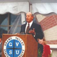Richard DeVos giving a speech at a podium,